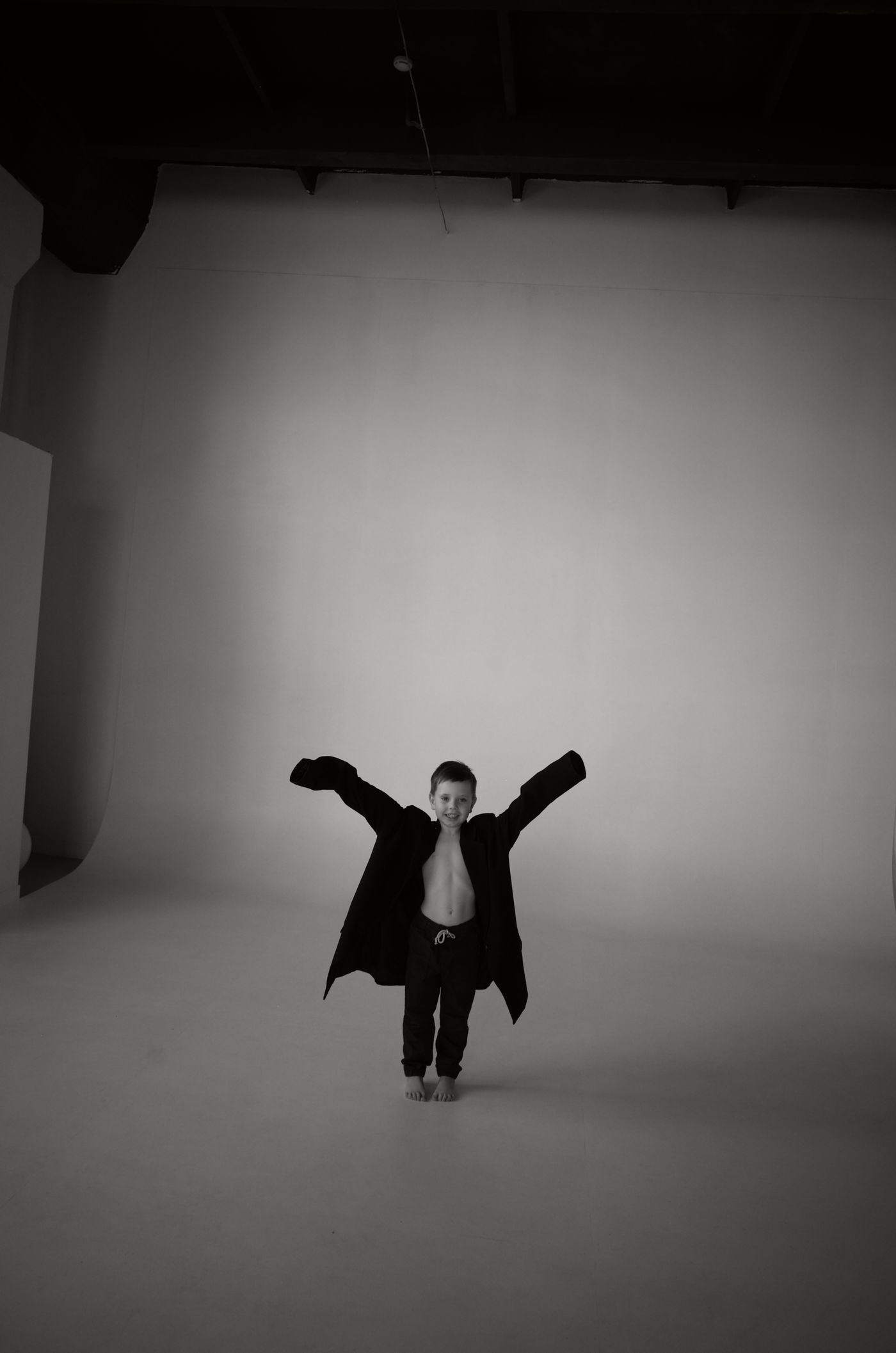 A child wearing an oversized jacket, with room to grow